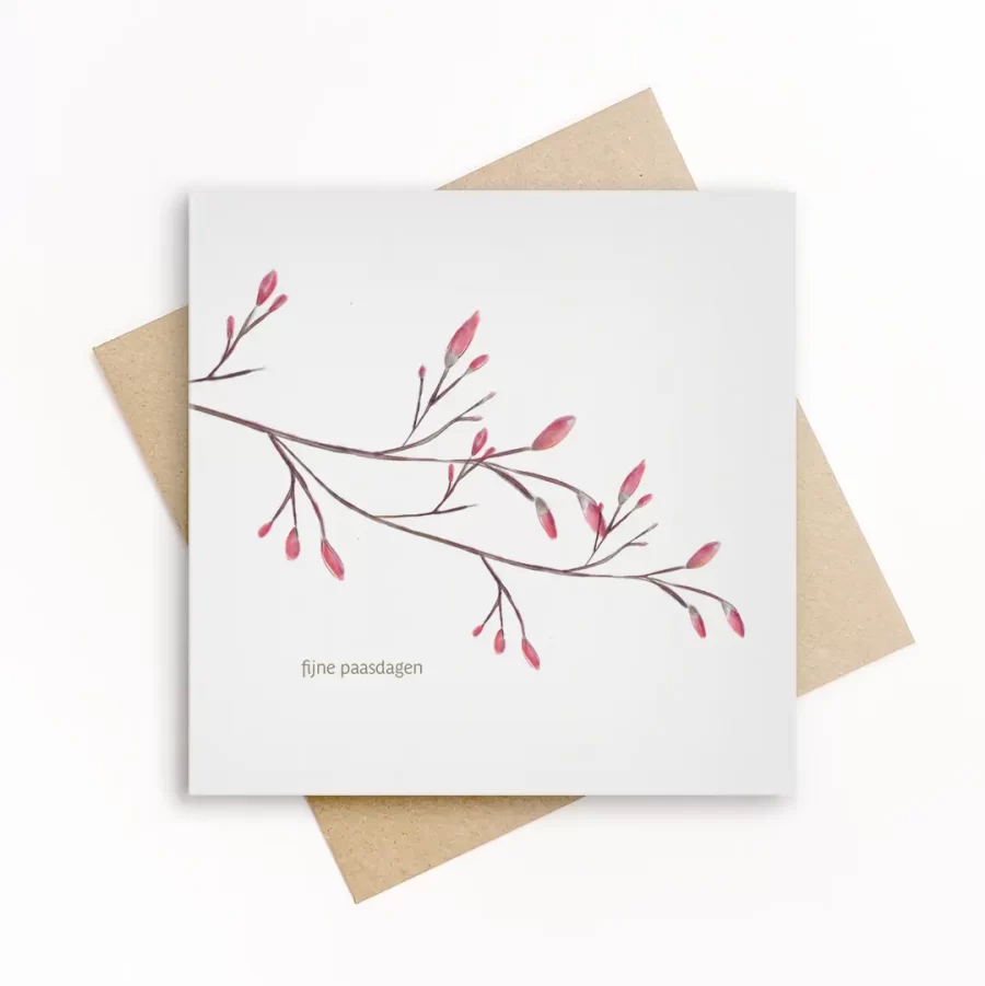 Eco-friendly paaswenskaart met een fijne tak met roze bloesemknoppen en de tekst fijne paasdagen, op wit papier met kraft envelop.